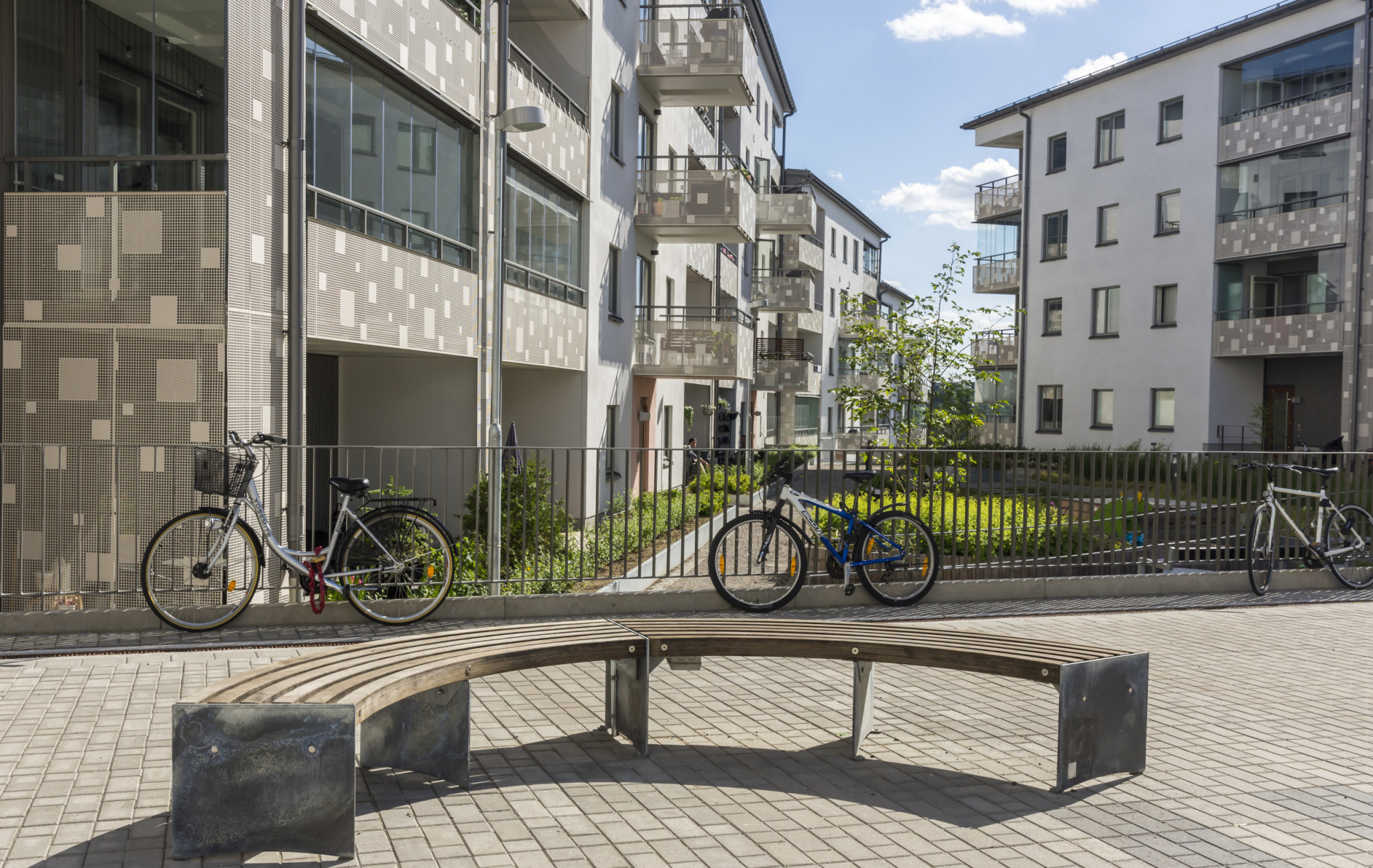 Nyproducerade och fräscha hyresrätter med grönområde och parkerade cyklar.